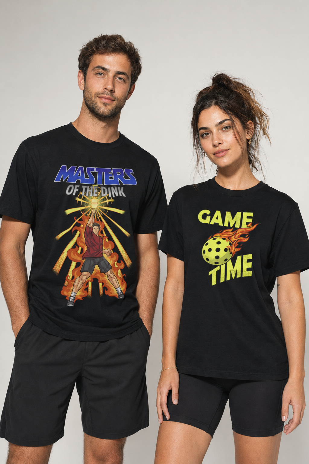 Male and female models wearing black pickleball graphic T-shirts featuring Masters of the Dink and Game Time designs