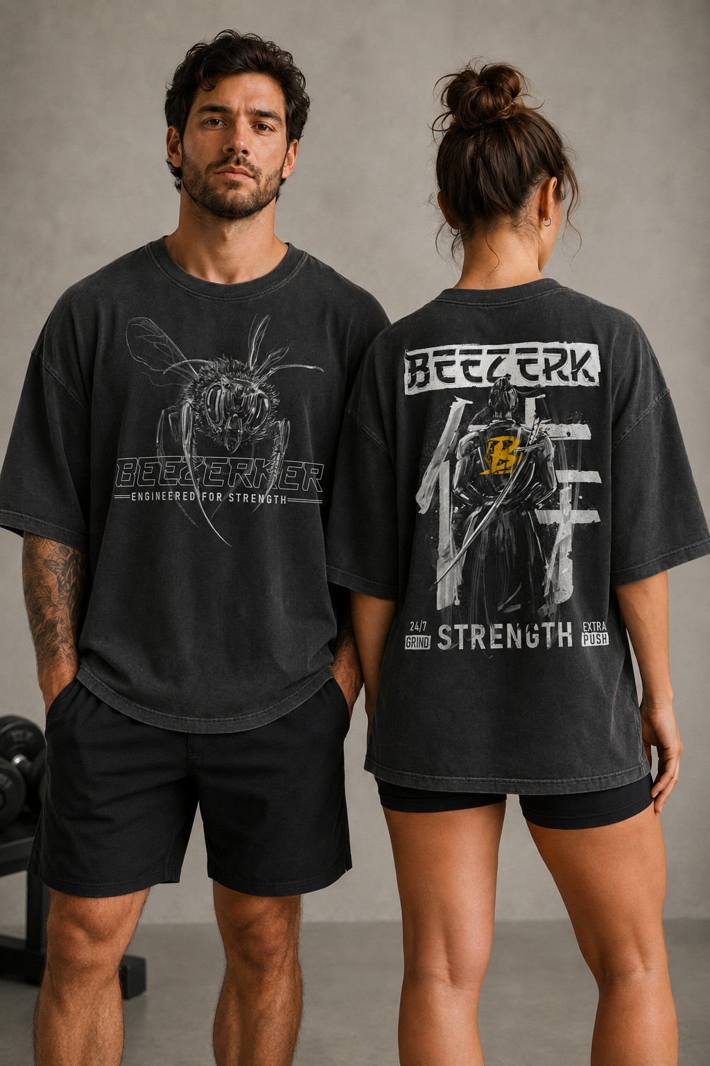 Models wearing oversized faded Beezerk gym graphic tees with mechanical bee front artwork and samurai back artwork
