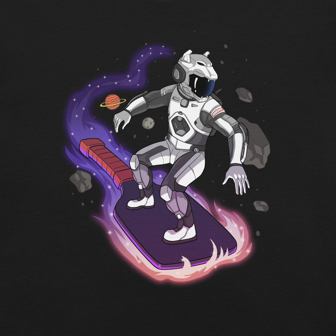 Cosmic Surfer pickleball graphic T-shirt featuring an armored space traveler riding a glowing paddle through planets and asteroids