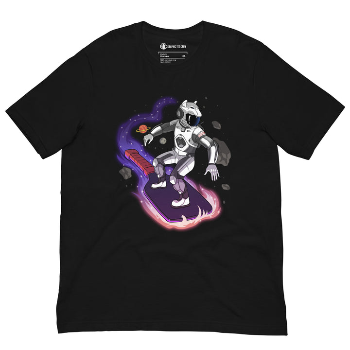Cosmic Surfer pickleball graphic T-shirt featuring an armored space traveler riding a glowing paddle through planets and asteroids