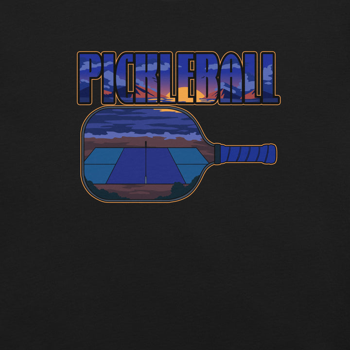 Sunset Court Pickleball T-Shirt featuring a mountain sunset and outdoor court inside bold pickleball lettering and a paddle graphic.