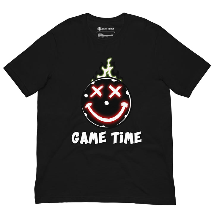 Game Time flaming pickleball graphic T-shirt featuring glowing red X-shaped eyes, a smiling face and green flames